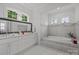 Luxurious bathroom with a soaking tub, double vanity, and modern lighting, creating a spa-like experience at 2117 Middlebridge Ct, Fort Mill, SC 29715