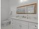 Elegant bathroom featuring marble countertops, white cabinets and gold trimmed mirror at 2117 Middlebridge Ct, Fort Mill, SC 29715