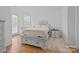 Cozy bedroom with hardwood floors, white walls, and soft natural light, creating a comfortable and inviting space at 2117 Middlebridge Ct, Fort Mill, SC 29715