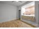 Bedroom featuring wooden floors and a cozy window seat with accent pillows at 2117 Middlebridge Ct, Fort Mill, SC 29715