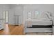 Bright bedroom with hardwood floors, white walls, and access to a patio, perfect for relaxing and enjoying the outdoors at 2117 Middlebridge Ct, Fort Mill, SC 29715
