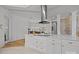 Bright kitchen features a white island with quartz countertops and a stainless steel range hood at 2117 Middlebridge Ct, Fort Mill, SC 29715