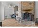 Cozy living area featuring a stone fireplace, stainless steel grill and hardwood floors, perfect for relaxation and entertainment at 2117 Middlebridge Ct, Fort Mill, SC 29715