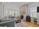 Bright and spacious living room with stone fireplace, hardwood floors, and ample seating at 2117 Middlebridge Ct, Fort Mill, SC 29715