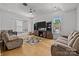 Entertainment room with a tv, hardwood floors, built-ins, and 2 large couches at 2117 Middlebridge Ct, Fort Mill, SC 29715