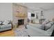 Cozy living room featuring a stone fireplace, hardwood floors, and comfortable seating at 2117 Middlebridge Ct, Fort Mill, SC 29715