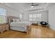 Spacious main bedroom with hardwood floors, tray ceilings, and a large window, creating a peaceful retreat at 2117 Middlebridge Ct, Fort Mill, SC 29715