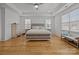 Bright bedroom with tray ceilings, hardwood floors, and large windows, offering ample natural light and a serene atmosphere at 2117 Middlebridge Ct, Fort Mill, SC 29715