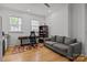Office with dark wood floors, two windows, sofa, and built in book shelves at 2117 Middlebridge Ct, Fort Mill, SC 29715