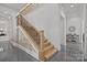 Beautiful staircase with wooden treads and a brick accent wall at 2117 Middlebridge Ct, Fort Mill, SC 29715