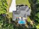 Aerial view of home with pool, patio, and surrounding wooded landscape at 2122 Goose Creek Farm Ln, Indian Trail, NC 28079