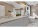 Elegant bathroom with double vanity, sleek fixtures, standalone tub, and a bright window at 2122 Goose Creek Farm Ln, Indian Trail, NC 28079