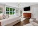 Stylish bedroom with hardwood floors, a view into the ensuite bathroom, and a modern television at 2122 Goose Creek Farm Ln, Indian Trail, NC 28079