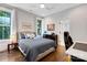 Cozy bedroom featuring hardwood floors, natural light, and tasteful nautical-themed decor at 2122 Goose Creek Farm Ln, Indian Trail, NC 28079
