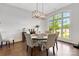 Bright dining room featuring hardwood floors, shiplap accent wall, and natural light from the large window at 2122 Goose Creek Farm Ln, Indian Trail, NC 28079
