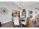 Cozy dining room with a round table, modern chandelier, and views to the entryway and kitchen at 2122 Goose Creek Farm Ln, Indian Trail, NC 28079
