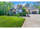 Charming home with stone and brick exterior, lush landscaping, and manicured lawn at 2122 Goose Creek Farm Ln, Indian Trail, NC 28079
