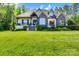 Charming home featuring a stone and white brick facade and a well-manicured front lawn at 2122 Goose Creek Farm Ln, Indian Trail, NC 28079