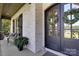 Cozy front porch features a seating area, brick facade, dark shutters, and an inviting entryway at 2122 Goose Creek Farm Ln, Indian Trail, NC 28079