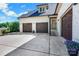 Spacious three-car garage with stylish doors and well-maintained driveway at 2122 Goose Creek Farm Ln, Indian Trail, NC 28079