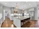 Modern kitchen with a large island, granite countertops, stainless steel appliances and hardwood floors at 2122 Goose Creek Farm Ln, Indian Trail, NC 28079