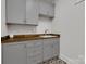 Well-organized laundry room with custom cabinetry, ample counter space, and stylish patterned floor at 2122 Goose Creek Farm Ln, Indian Trail, NC 28079