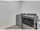 Functional laundry room with modern appliances and patterned tile floor at 2122 Goose Creek Farm Ln, Indian Trail, NC 28079