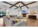 Comfortable living room with wood-beamed ceiling, fireplace, and ample seating at 2122 Goose Creek Farm Ln, Indian Trail, NC 28079