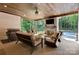 Inviting outdoor patio featuring a stone fireplace, ample seating, and a view of the backyard at 2122 Goose Creek Farm Ln, Indian Trail, NC 28079