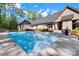 Backyard with a sparkling swimming pool, lounge chairs, and a well-maintained patio area at 2122 Goose Creek Farm Ln, Indian Trail, NC 28079