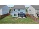 Aerial view of the spacious backyard featuring a patio and a charming gazebo with outdoor furniture at 214 Hidden Lakes Rd, Statesville, NC 28677