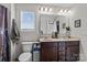 Bright bathroom featuring a double sink vanity, tiled floors, and a large mirror at 214 Hidden Lakes Rd, Statesville, NC 28677