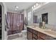 Bathroom with double sink vanity, a shower with a decorative curtain, and a neutral color palette at 214 Hidden Lakes Rd, Statesville, NC 28677