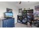 This bedroom features a blue dresser with a TV and dark shelves displaying a variety of Star Wars and Lego memorabilia at 214 Hidden Lakes Rd, Statesville, NC 28677