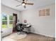 Bright bedroom featuring wood-look floors, a ceiling fan, and a window with a view of the yard at 214 Hidden Lakes Rd, Statesville, NC 28677