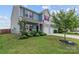 Charming two-story home with a well-manicured lawn and a two-car garage at 214 Hidden Lakes Rd, Statesville, NC 28677