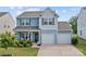 Charming two-story home with a well-manicured lawn and a two-car garage at 214 Hidden Lakes Rd, Statesville, NC 28677