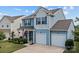 Charming two-story home with a well-manicured lawn and a two-car garage at 214 Hidden Lakes Rd, Statesville, NC 28677