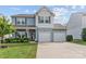 Charming two-story home with a well-manicured lawn and a two-car garage at 214 Hidden Lakes Rd, Statesville, NC 28677