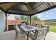 Covered gazebo with comfortable outdoor seating, a grill, and string lights for ambiance at 214 Hidden Lakes Rd, Statesville, NC 28677