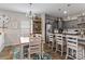 Bright kitchen featuring an island, gray cabinets, stainless steel appliances, and a dining area at 214 Hidden Lakes Rd, Statesville, NC 28677