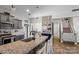 Well-appointed kitchen featuring granite countertops, an island with seating, and easy access to other living spaces at 214 Hidden Lakes Rd, Statesville, NC 28677