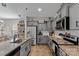 Modern kitchen boasting gray cabinets, stainless steel appliances, granite countertops, and open shelving at 214 Hidden Lakes Rd, Statesville, NC 28677