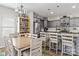 Open concept kitchen with island seating, gray cabinets, and stainless steel appliances flowing into the dining area at 214 Hidden Lakes Rd, Statesville, NC 28677