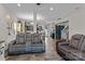 Spacious living room with hardwood floors, comfortable seating, and open access to the kitchen and dining area at 214 Hidden Lakes Rd, Statesville, NC 28677