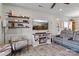 Cozy living room featuring a fireplace, floating shelves, and comfortable seating on stylish wood-look floors at 214 Hidden Lakes Rd, Statesville, NC 28677