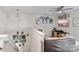 The loft features a neutral colored couch, ceiling fan, mounted TV, and decoratively designed walls at 214 Hidden Lakes Rd, Statesville, NC 28677