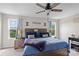 Bedroom with decorative pillows, side tables, bedside lamps, and a ceiling fan above a comfortable bed at 214 Hidden Lakes Rd, Statesville, NC 28677