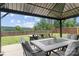 Inviting covered patio with outdoor seating, overlooking a well-maintained lawn and a scenic wooded area at 214 Hidden Lakes Rd, Statesville, NC 28677