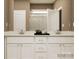 Bathroom with double vanity featuring white cabinets and stone countertops, complemented by neutral wall tones at 2249 Moon Crest Rd, Lancaster, SC 29720